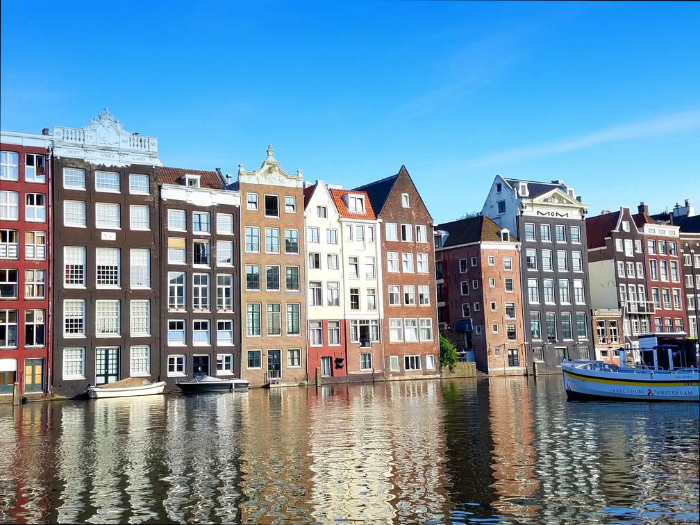 amsterdam damrak waterfront colorful buildings